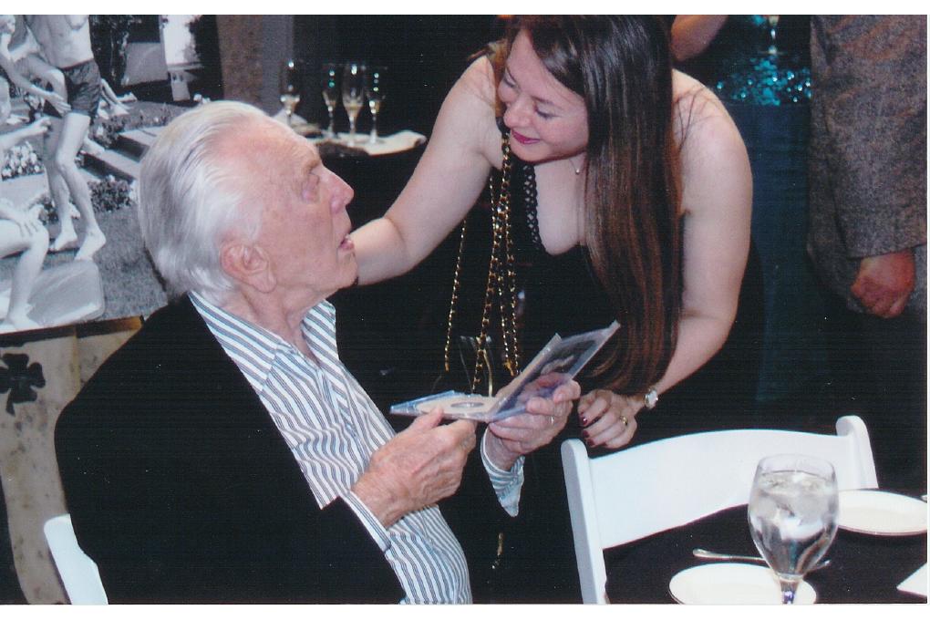 Olga Thomas presenting her recording to Kirk Douglas