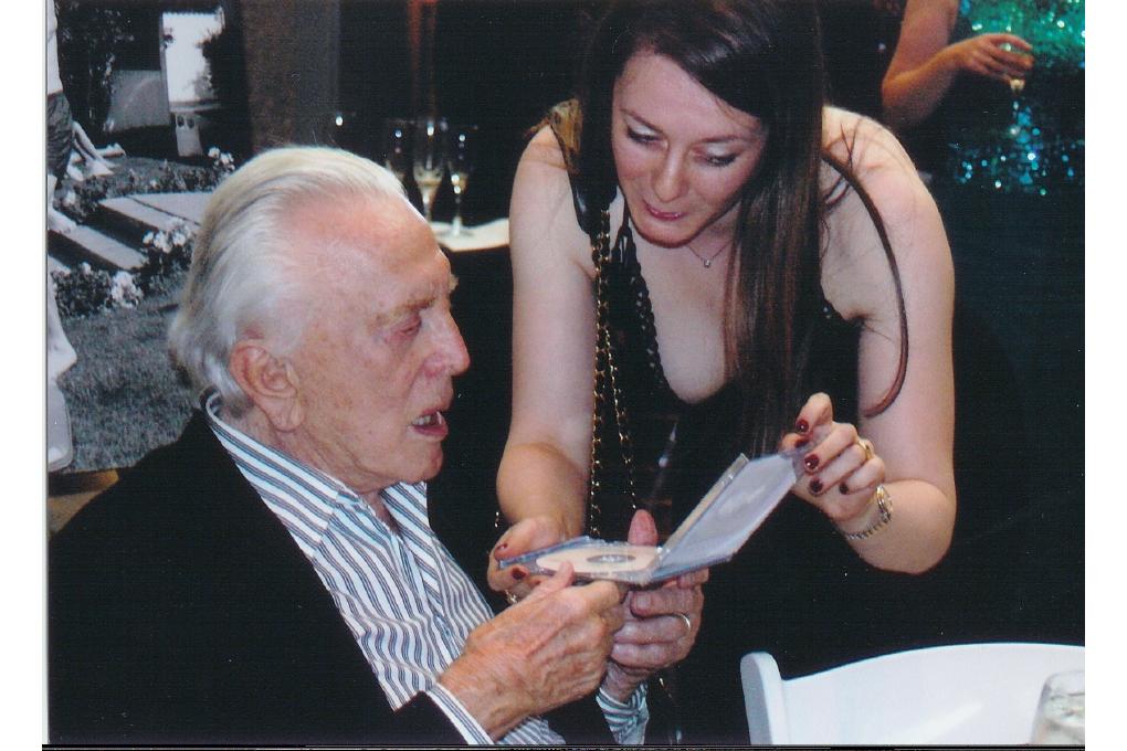 Kirk Douglas looking at Olga Thomas's recording