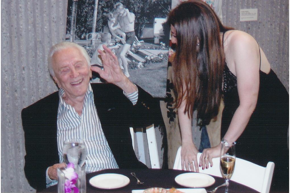 Olga Thomas speaking with Kirk Douglas